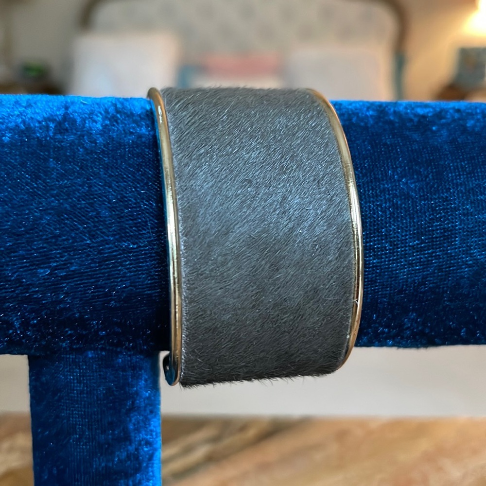Faux calf hair cuff with gold interior.